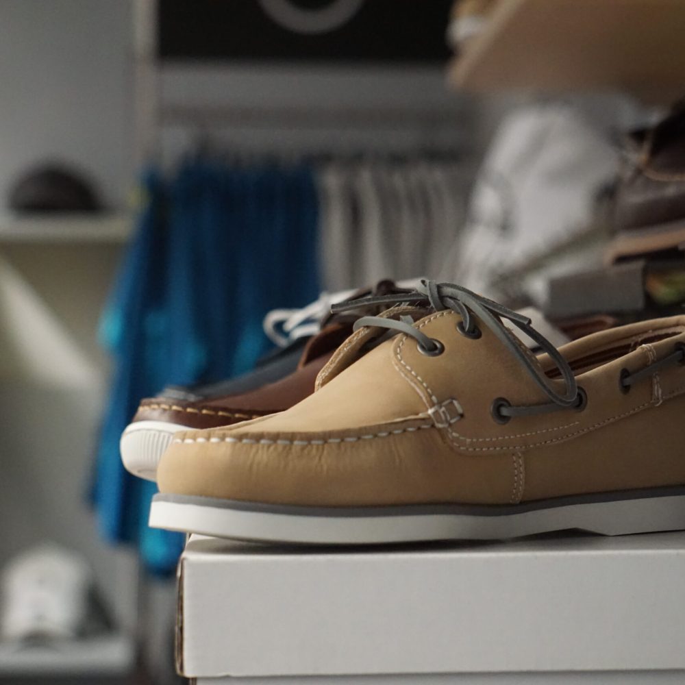 Hellbraune und dunkelbraune Bootsschuhe aus Leder auf einem Regal im GTS Sports Laden